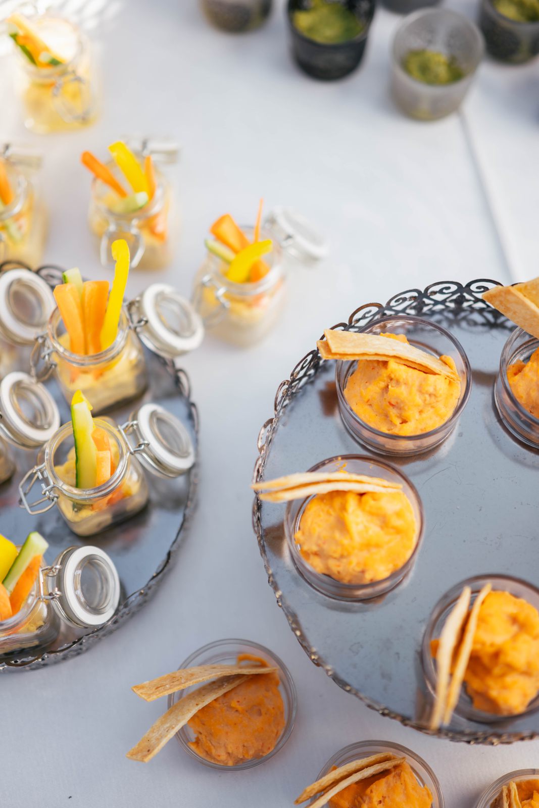 Colorful finger food in small glass jars