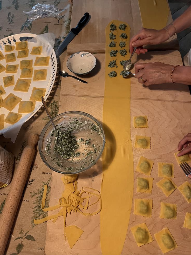 Filling ravioli along a long sheet of fresh pasta